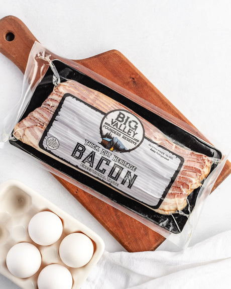 a pack of thick cut bacon on a cutting board