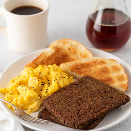 slices of fried scrapple with eggs and toast on a plate