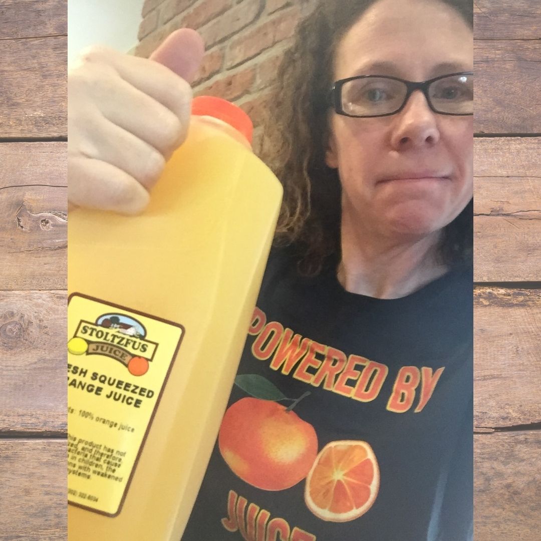 Elise and a jug of Stoltzfus Meats fresh squeezed orange juice
