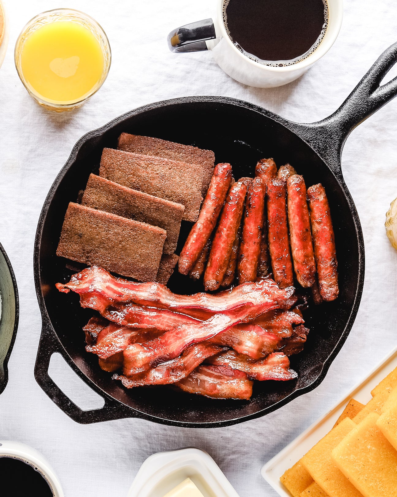 Scrapple bacon and sausage in a cast iron pan