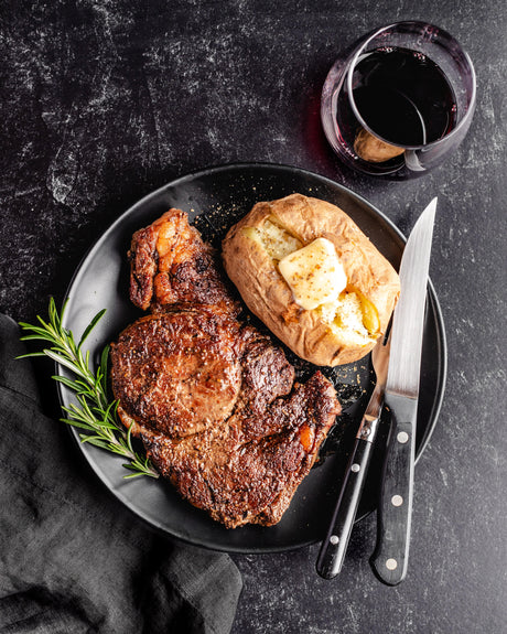 a grilled ribeye steak with baked potato