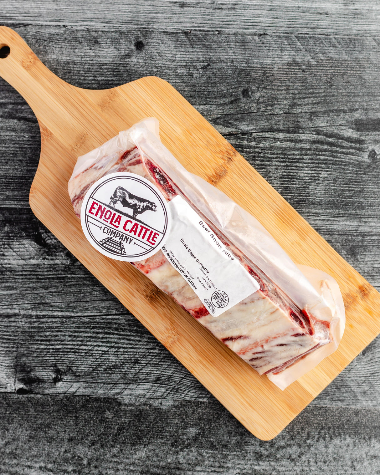 a pack of short ribs on a cutting board