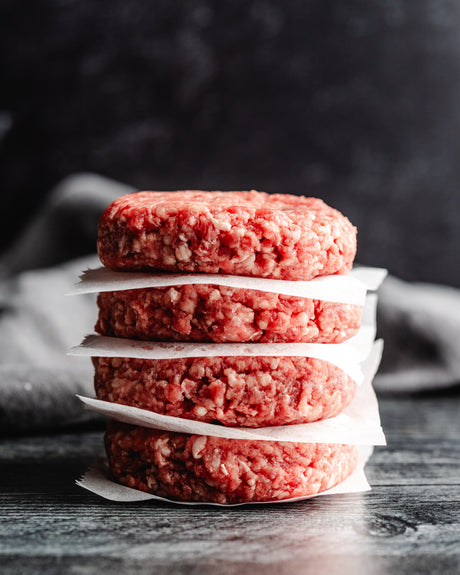 a stack of fresh beef patties