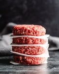 a stack of fresh beef patties