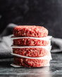 a stack of fresh beef patties