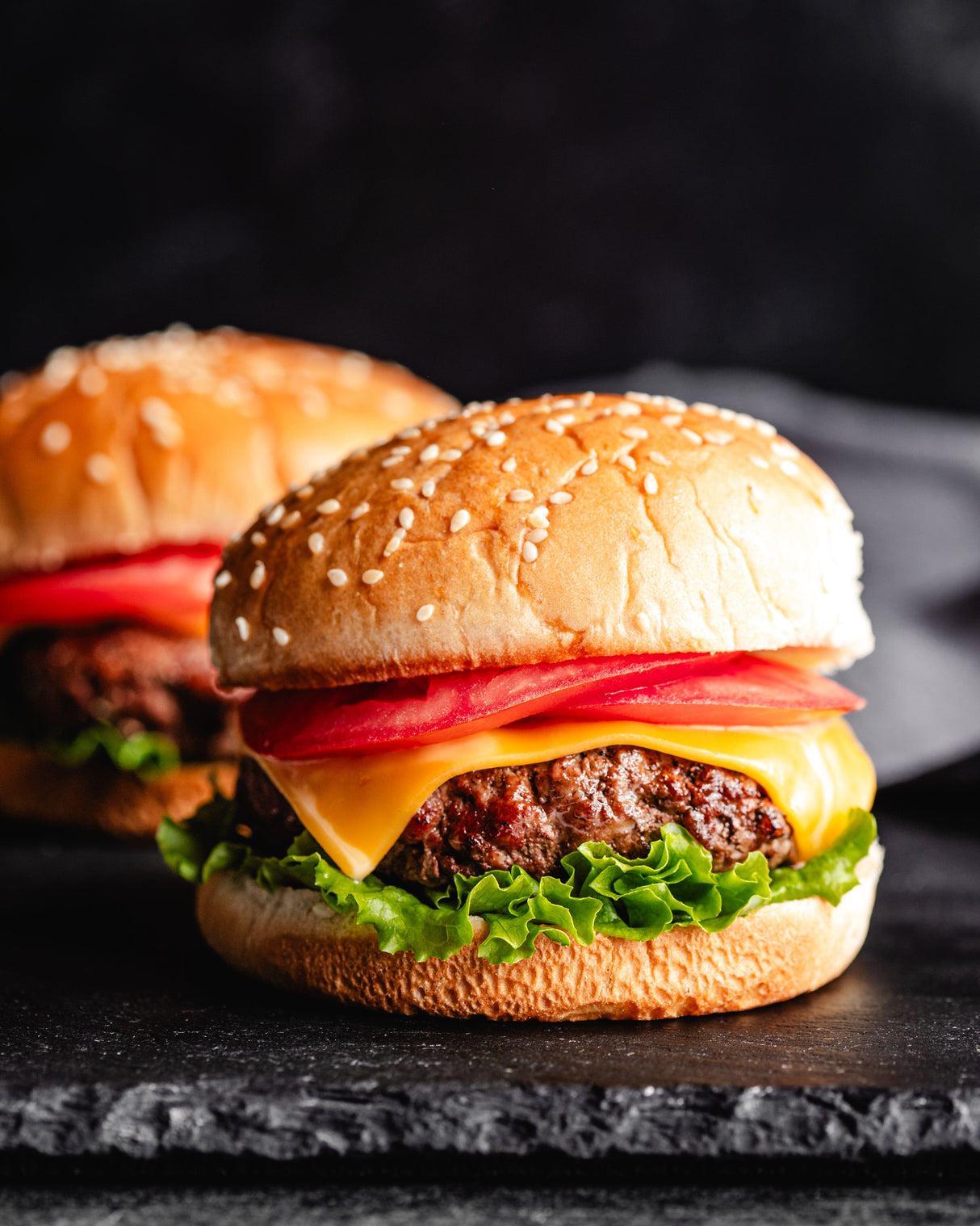 a cheeseburger with a sesame seed bun