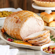 a sliced boneless turkey breast roast on serving dish