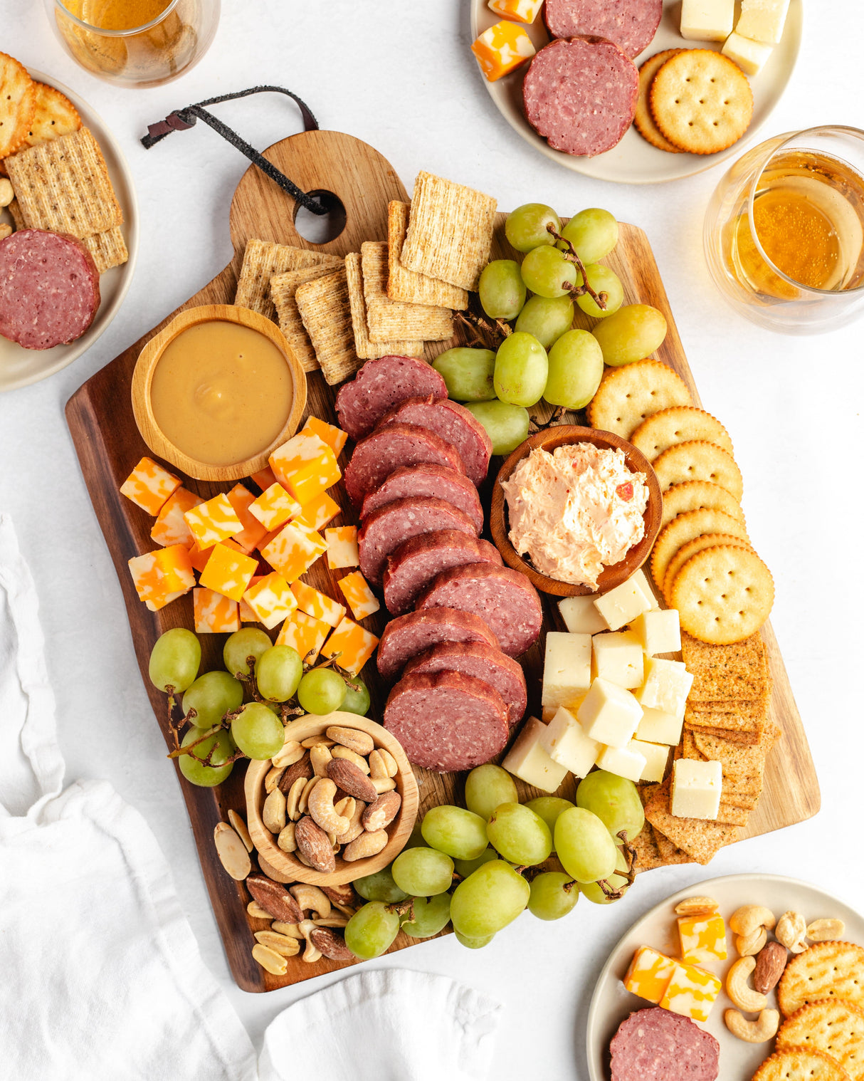 a charcuterie board featuring sliced beef bologna