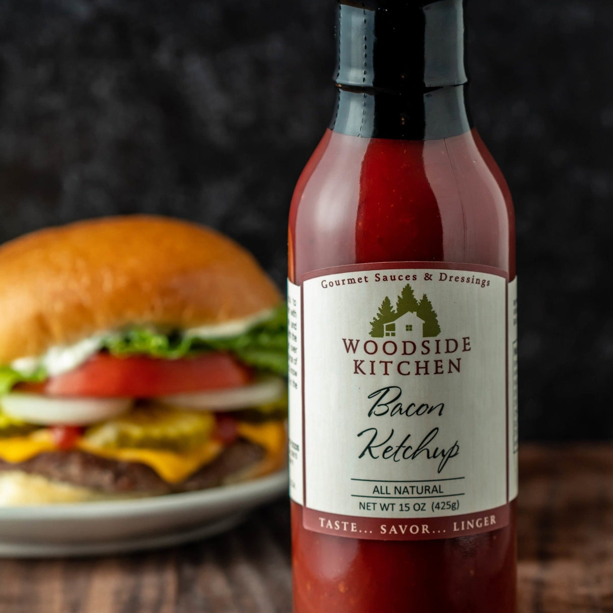 a jar of bacon ketchup with a burger