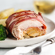 a bacon wrapped cordon bleu on a plate